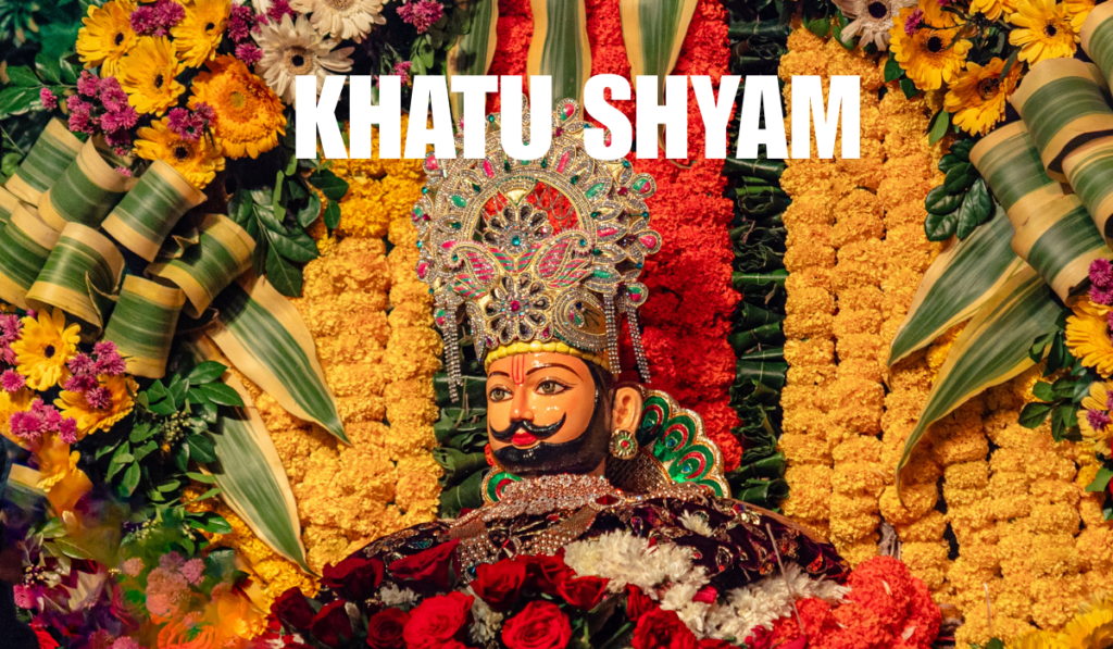 A beautifully decorated idol of Khatu Shyam Ji surrounded by vibrant flowers and colorful garlands during temple darshan.